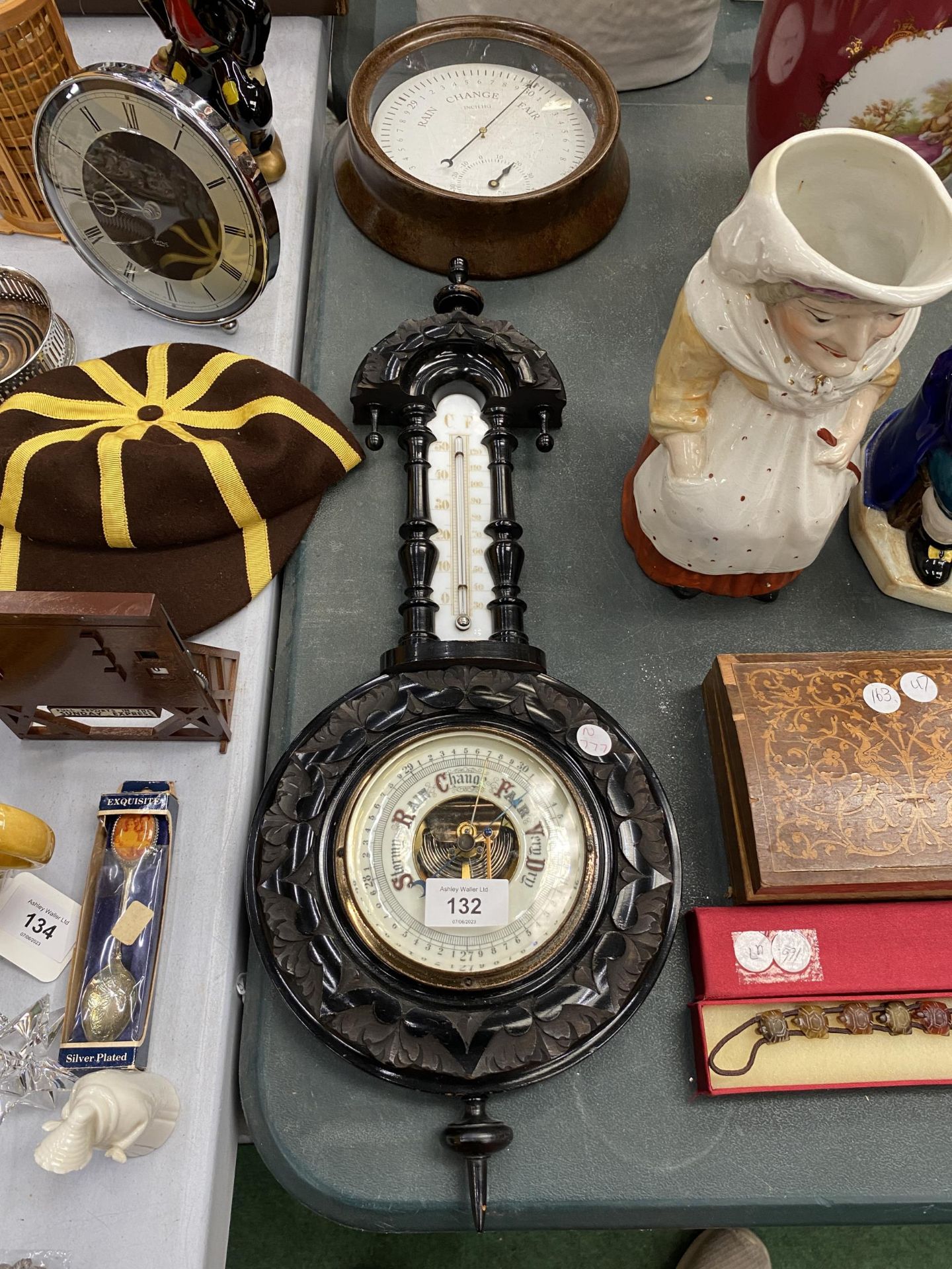 AN EBONY FRAMED VINTAGE BAROMETER AND THERMOMETER PLUS A ROUND METAL BAROMETER