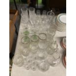 A LARGE QUANTITY OF GLASSES TO INCLUDE WINE, SHERRY, TUMBLERS, JUGS, ETC