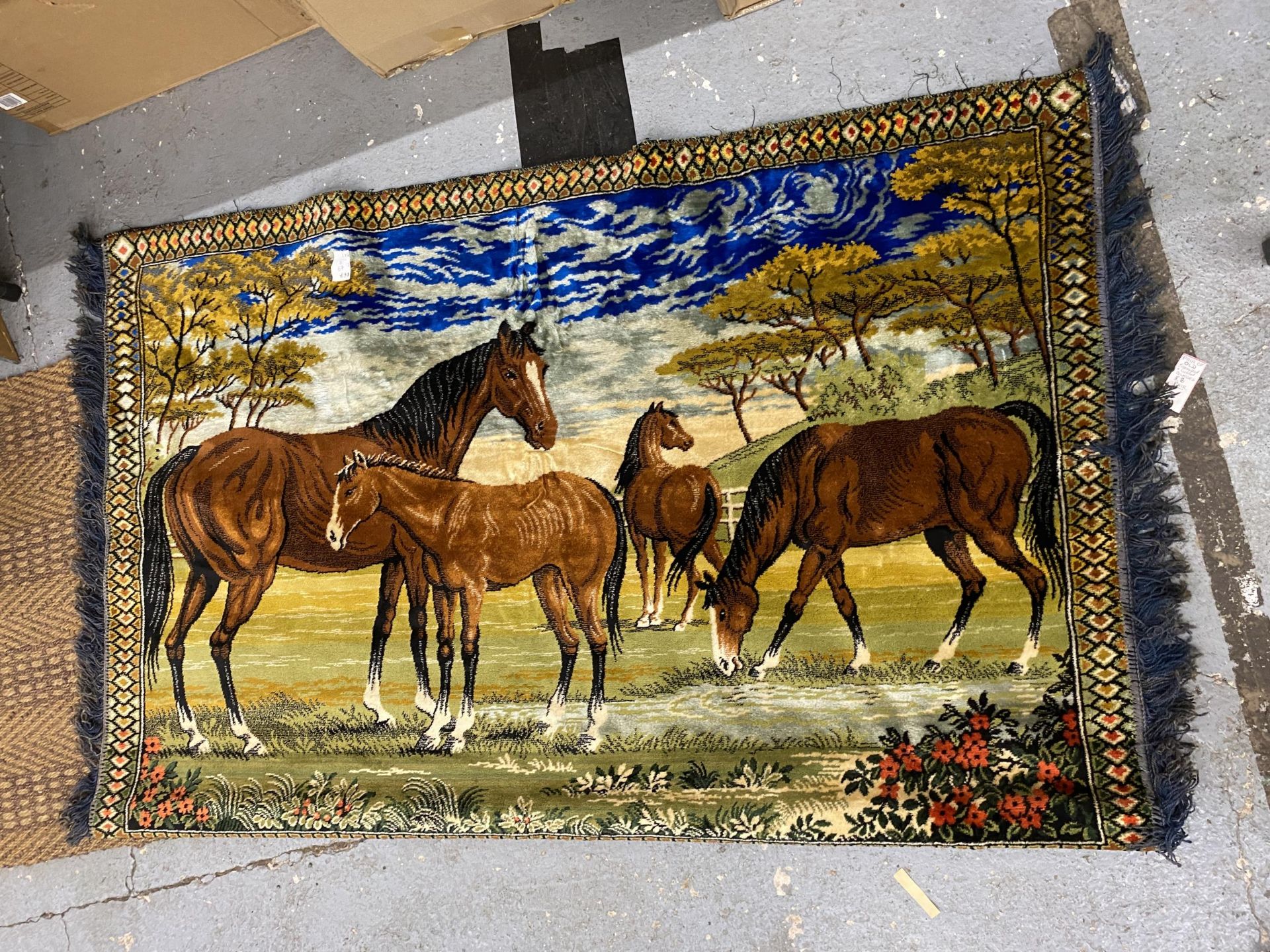 A VINTAGE HANFING TAPESTRY OF HORSES