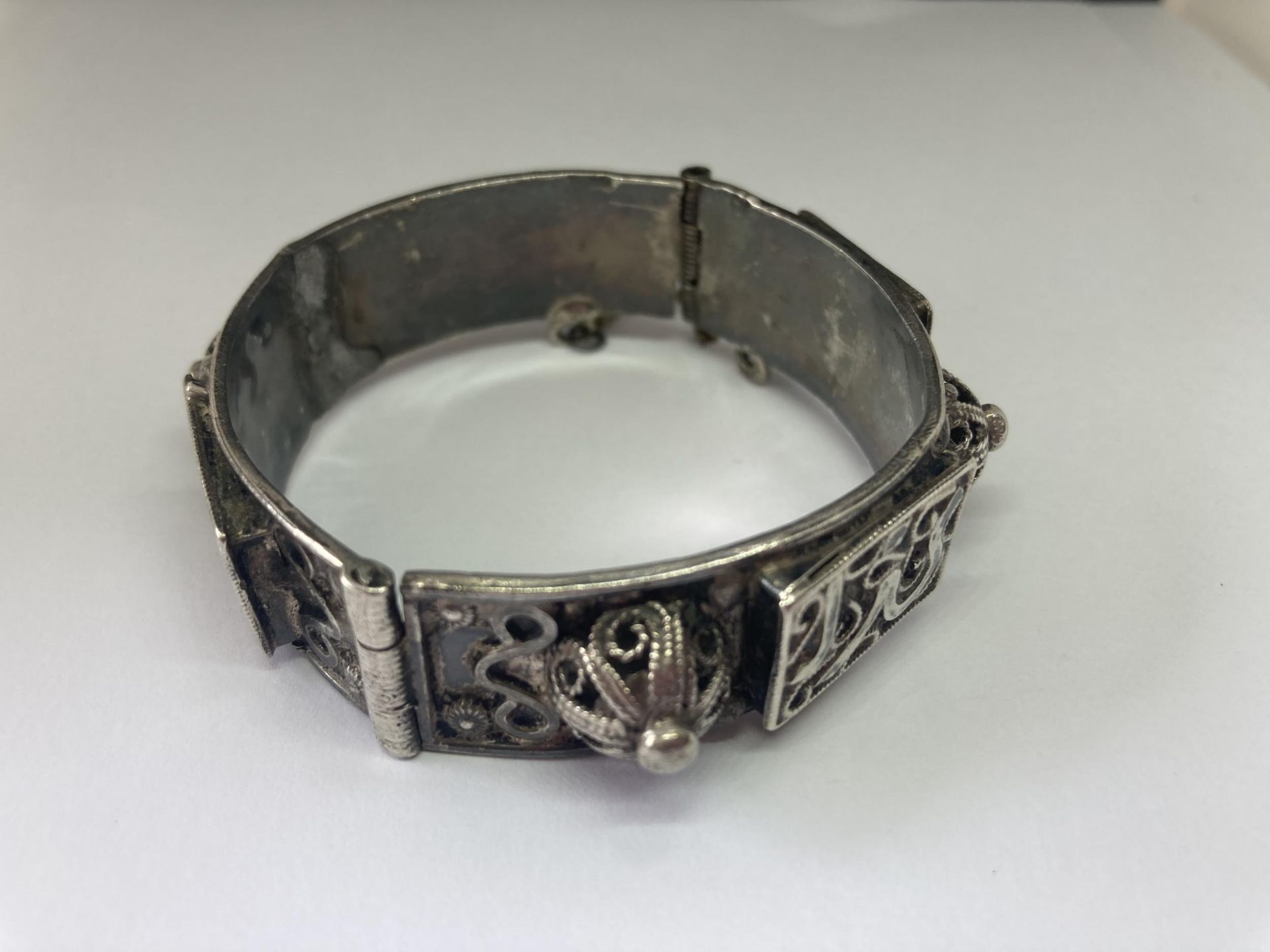 A SILVER EASTERN BANGLE