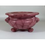 A C.1900 ART NOUVEAU BRETBY PINK POTTERY CENSOR / BOWL WITH TRIPLE LION HEAD AND PAW FEET, SIGNED TO
