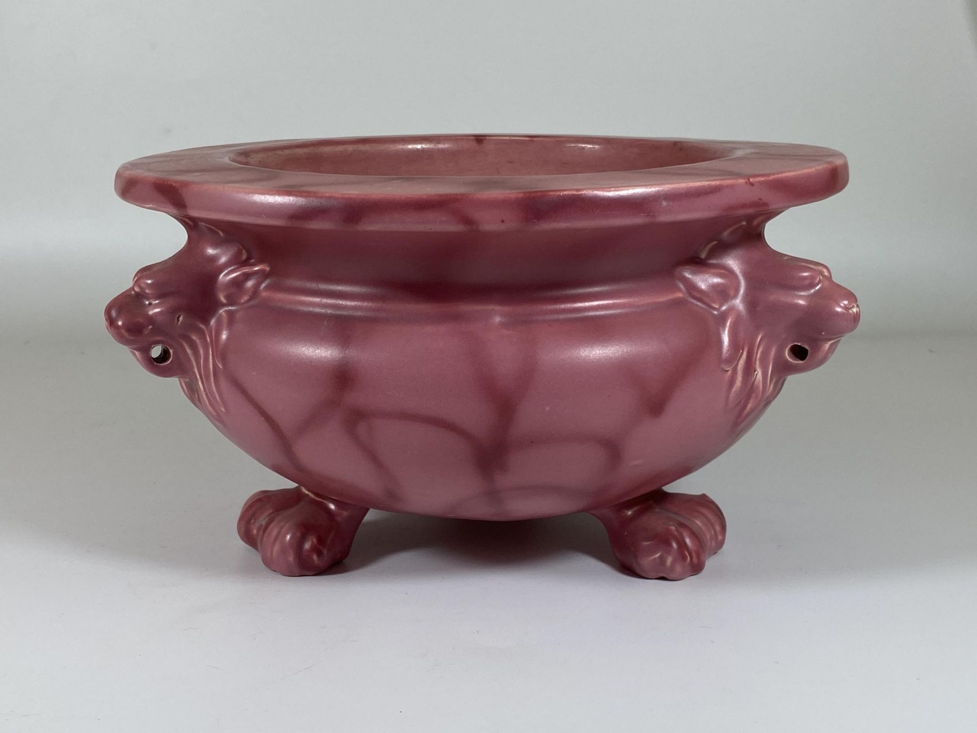 A C.1900 ART NOUVEAU BRETBY PINK POTTERY CENSOR / BOWL WITH TRIPLE LION HEAD AND PAW FEET, SIGNED TO