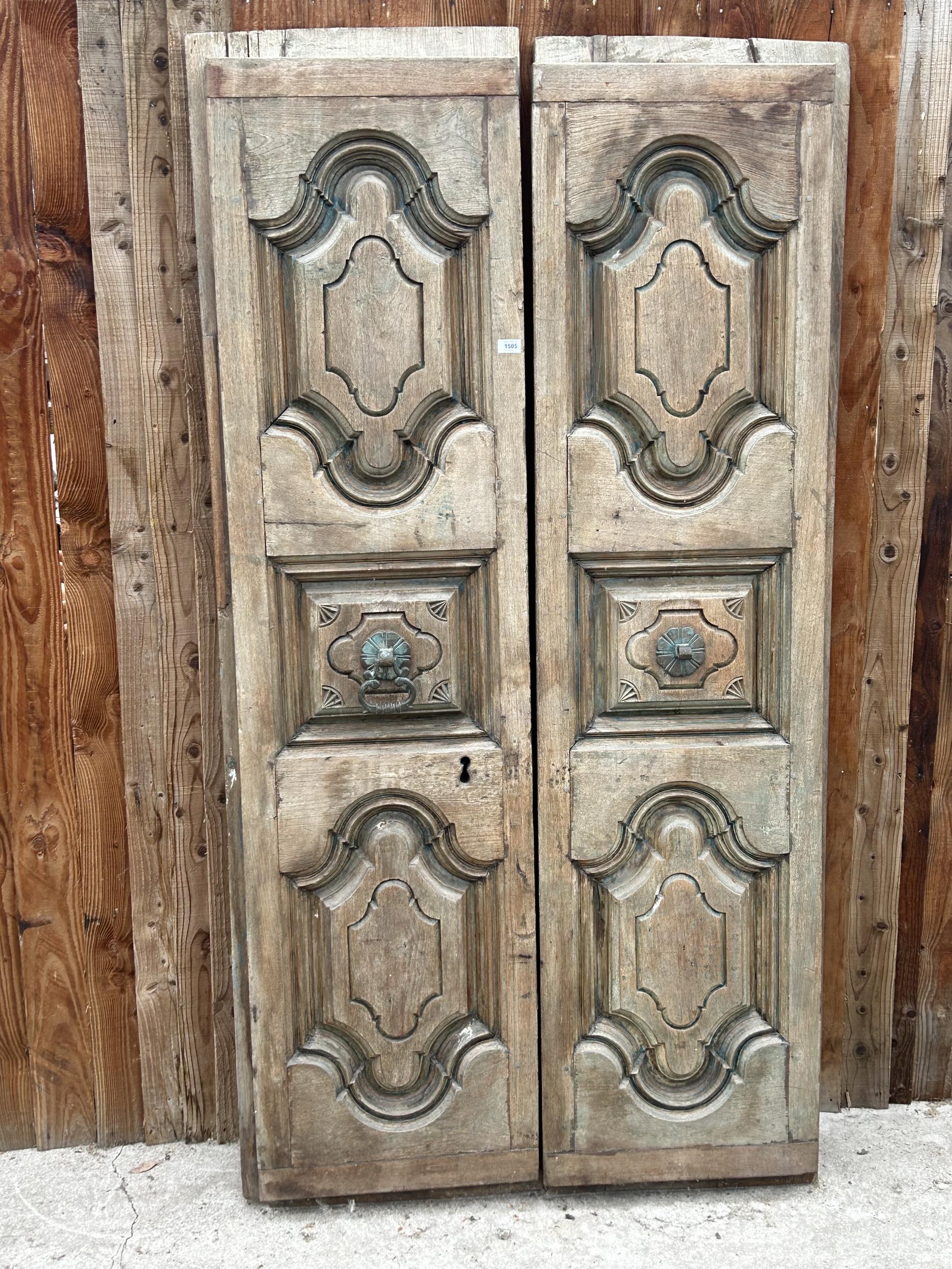 A PAIR OF INDIAN HARDWOOD PANELLED DOORS WITH BRASS HANDLES (ONE PIECE MISSING) 77 X 41"