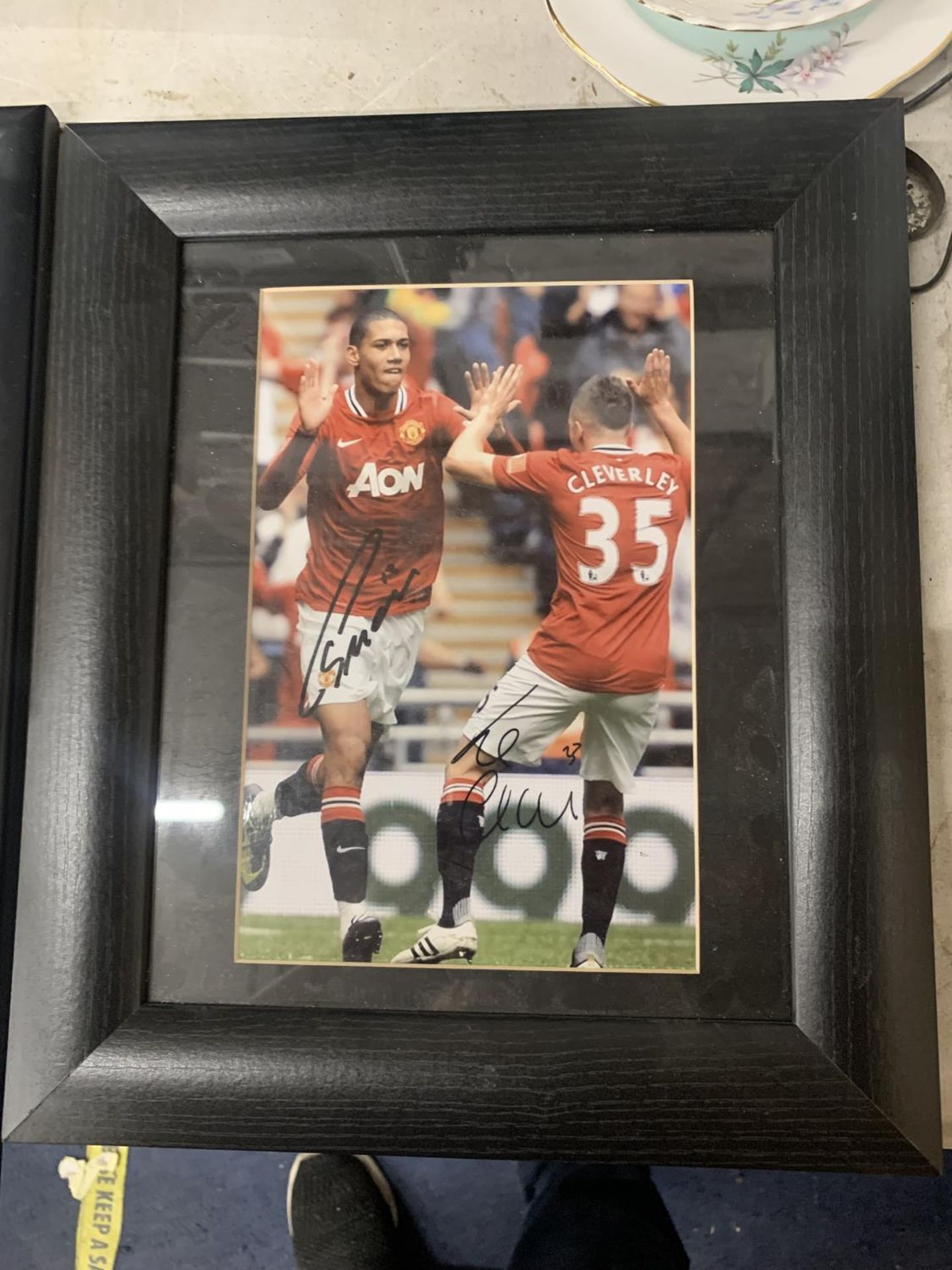 A FRAMED SIGNED PHOTO OF CHRIS SMALLING AND CLEVERLEY