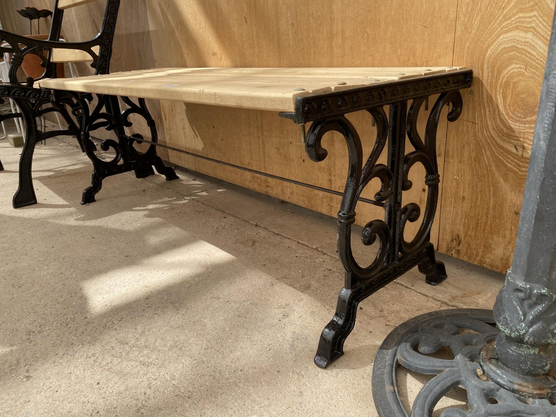 A WOODEN SLATTED TABLE WITH CAST IRON BENCH ENDS - Image 2 of 3