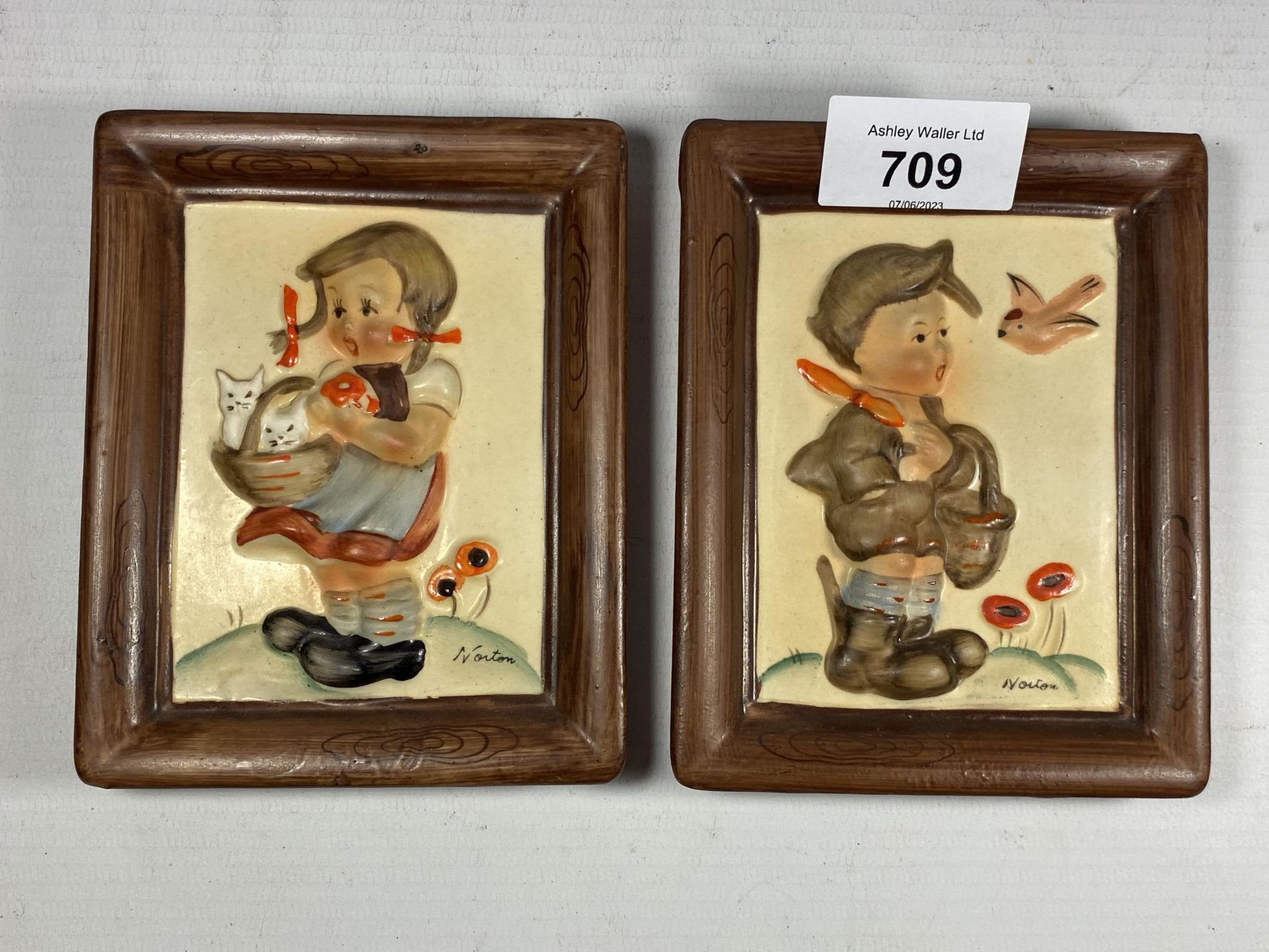 A PAIR OF SMALL HUMMEL POTTERY FIGURAL PLAQUES