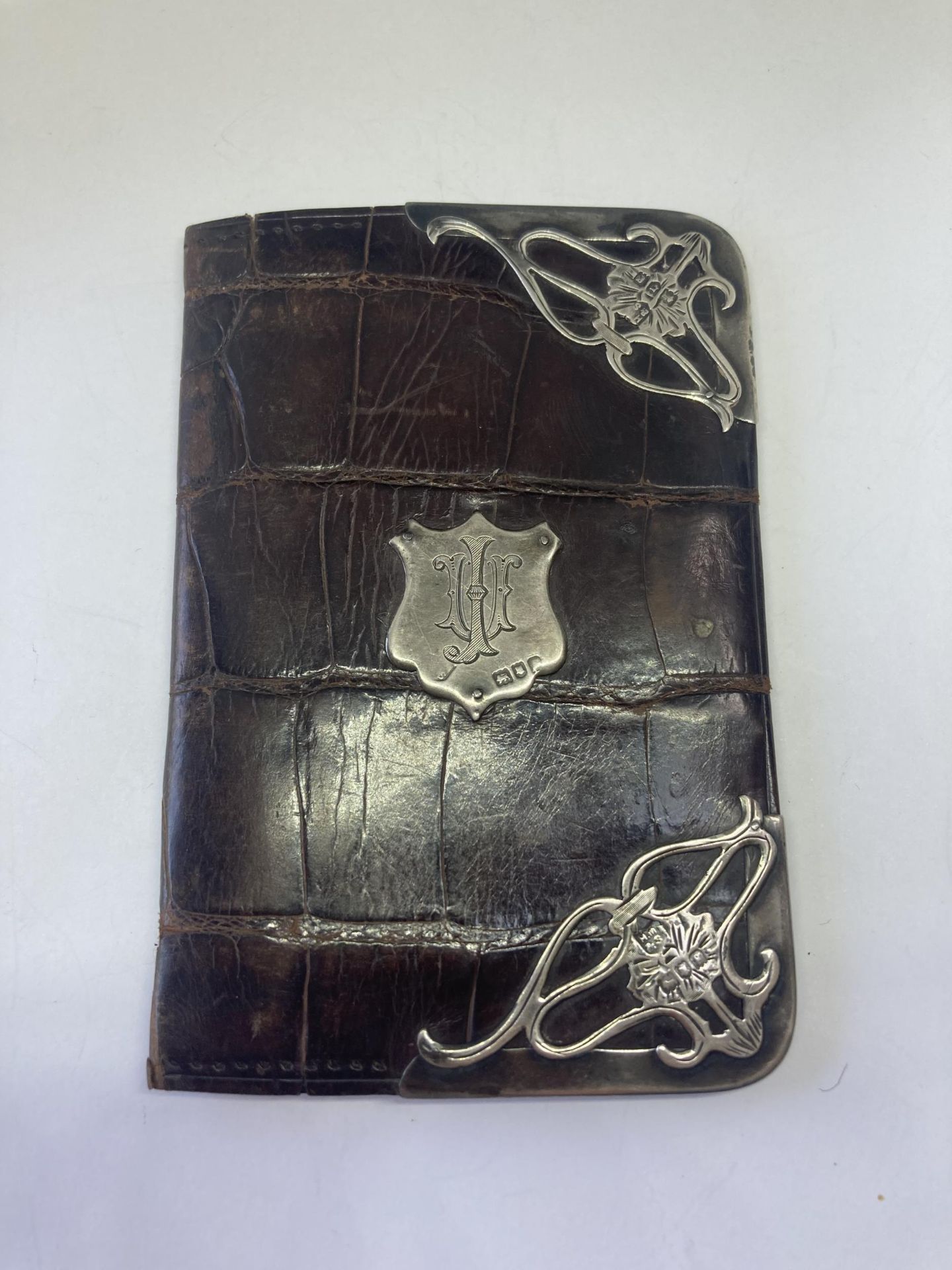A SILVER AND LEATHER WALLET