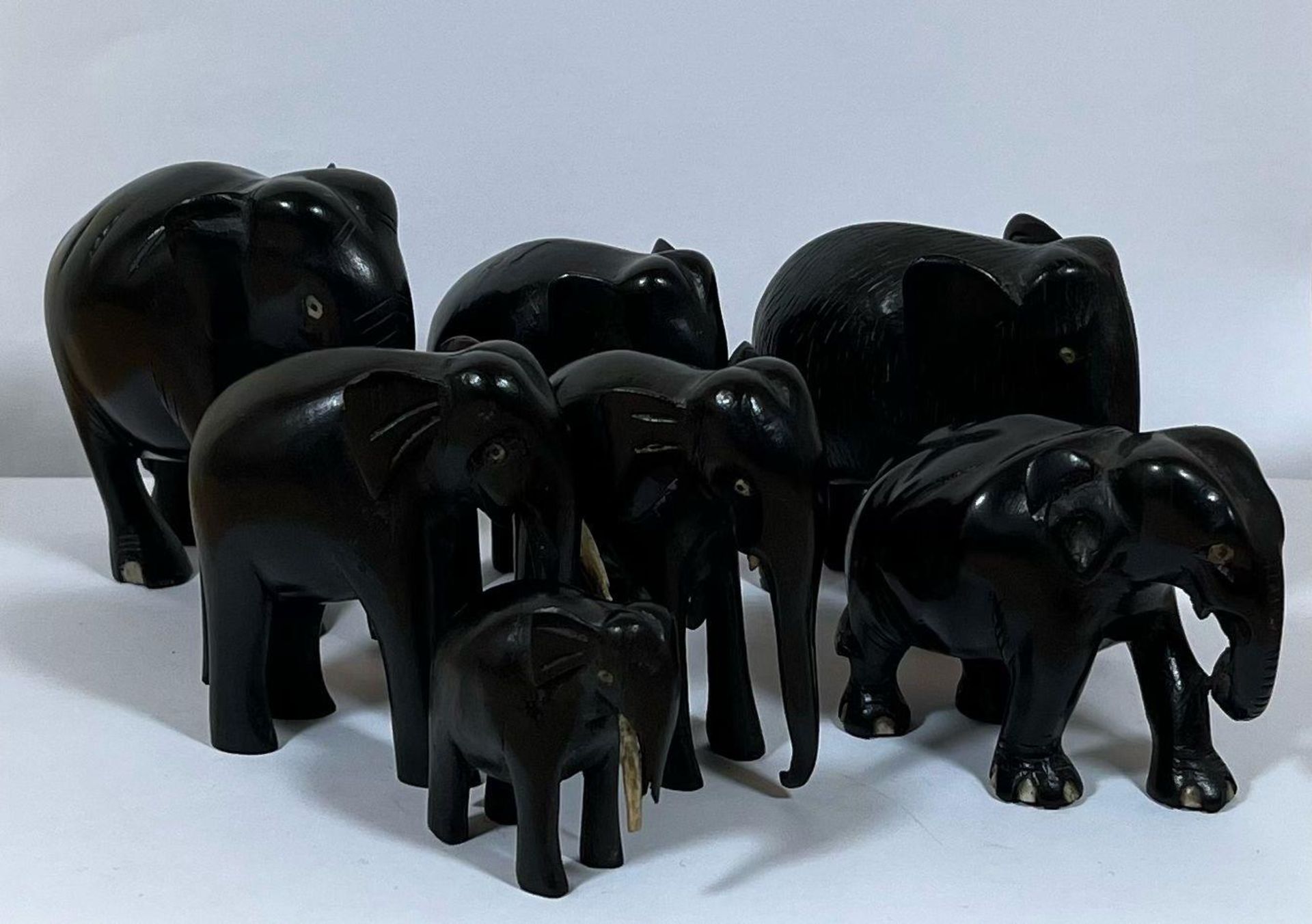 AN ANTIQUE GROUP OF SEVEN EBONY ELEPHANTS, LARGEST 9.5CM HEIGHT