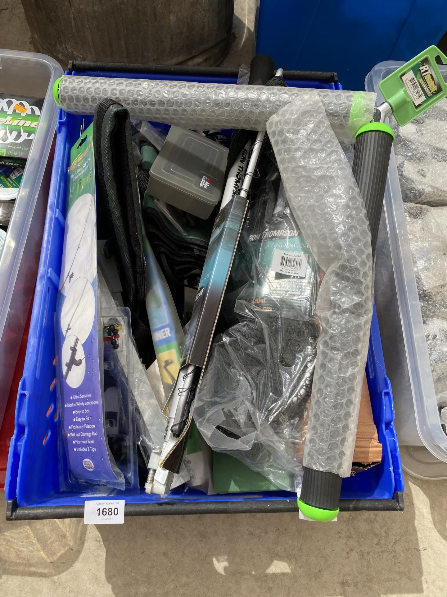 A BOX CONGTAINING AN ASSORTMENT OF FISHING TACKLE TO INCLUDE REELS, BITE INDICATORS AND ROD