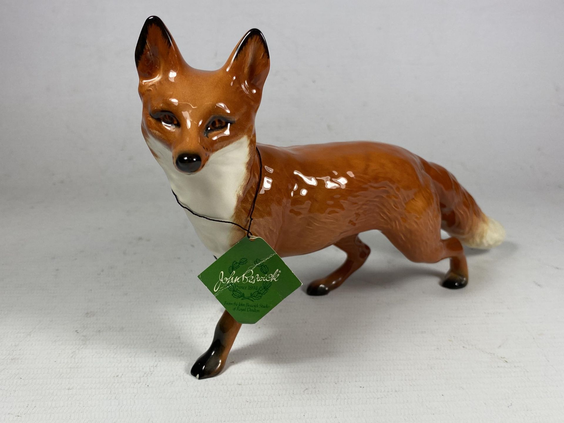 A BESWICK POTTERY MODEL OF A FOX