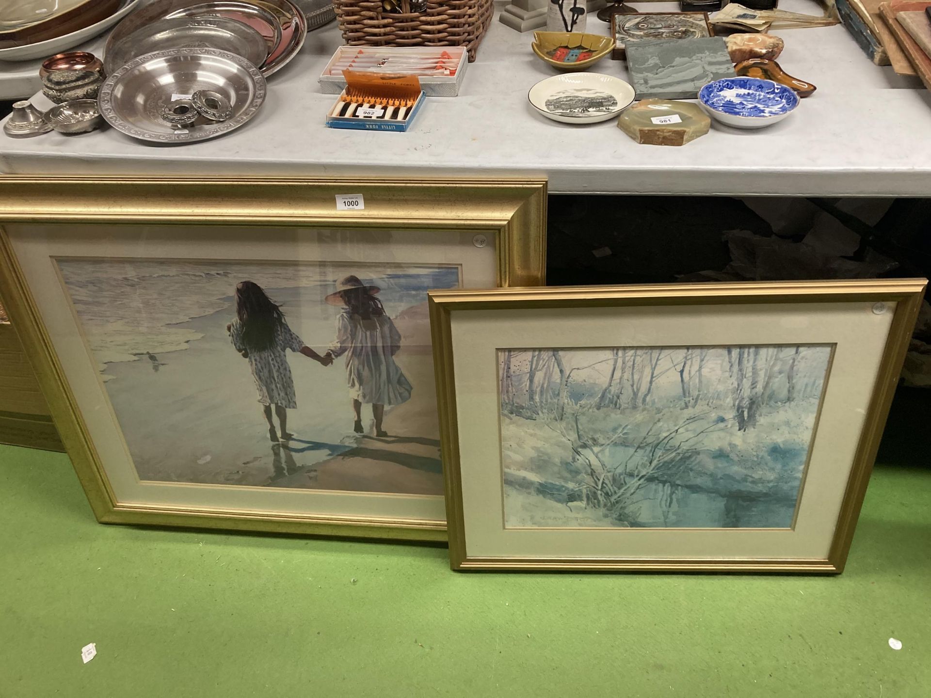 A LARGE GILT FRAMED PRINT OF CHILDREN ON A BEACH 86CM X 70.5CM PLUS A WOODLAND PRINT