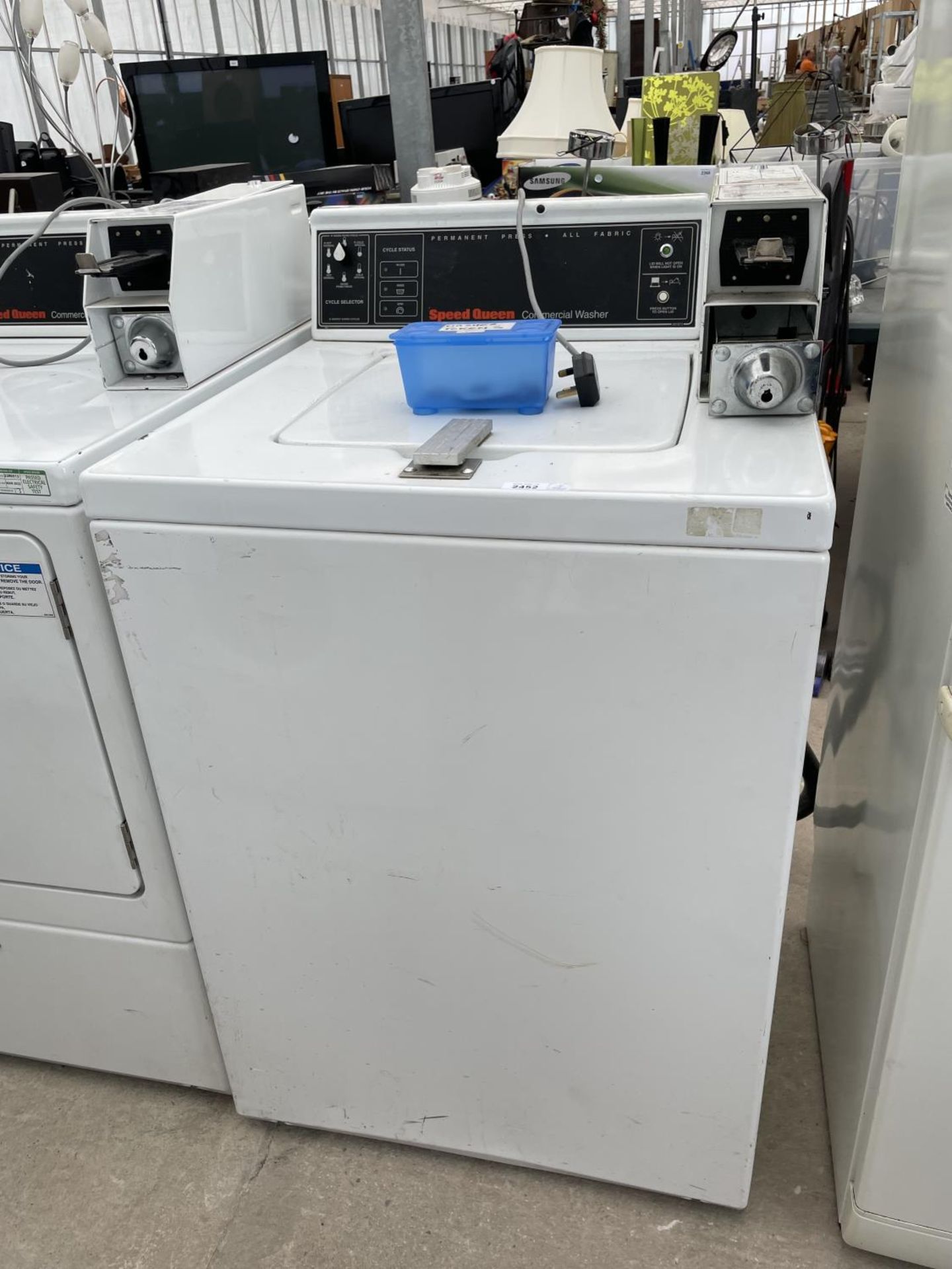 A SPEED QUEEN COMMERCIAL WASHER WITH TOKENS
