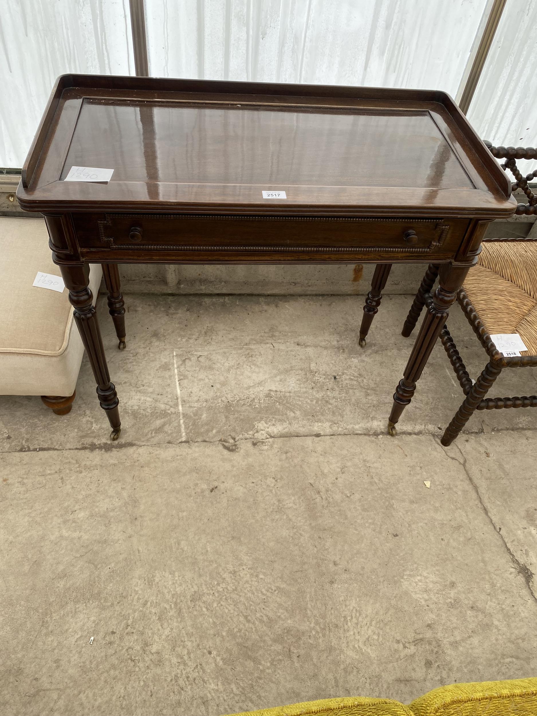 A REGENCY STYLE MAHOGANY SIDE-TABLE WITH GALLERY BACK, SINGLE DRAWER, ON TURNED AND FLUTED LEGS, 32"