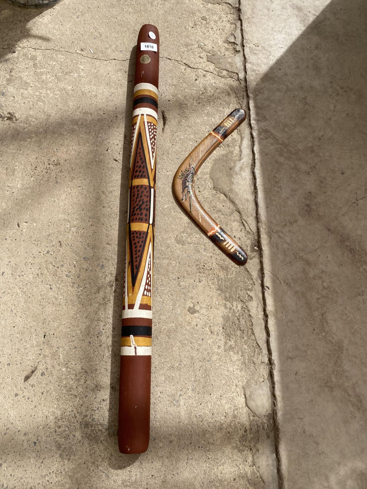 A WOODEN BOOMERANG AND A DIDGERIDOO