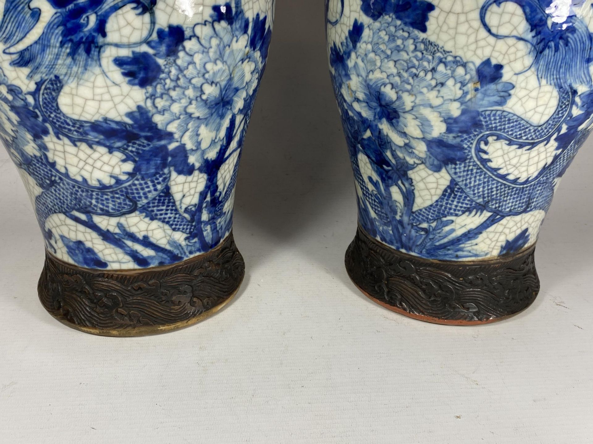A PAIR OF EARLY 20TH CENTURY CHINESE BLUE AND WHITE CRACKLE GLAZE DRAGON DESIGN VASES, A/F, HEIGHT - Image 5 of 13