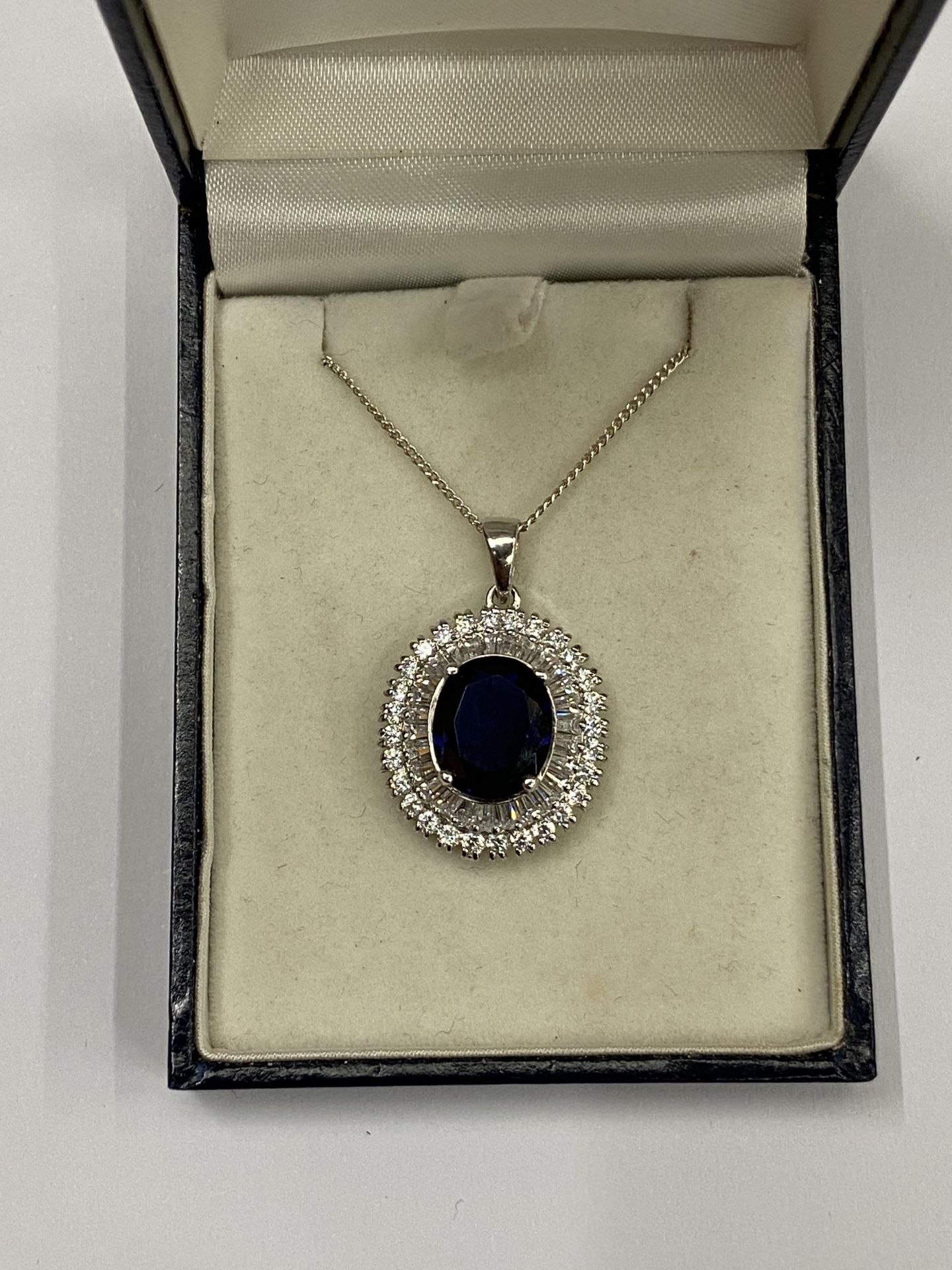 A SILVER AND SAPPHIRE STYLE PENDANT NECKLACE, BOXED