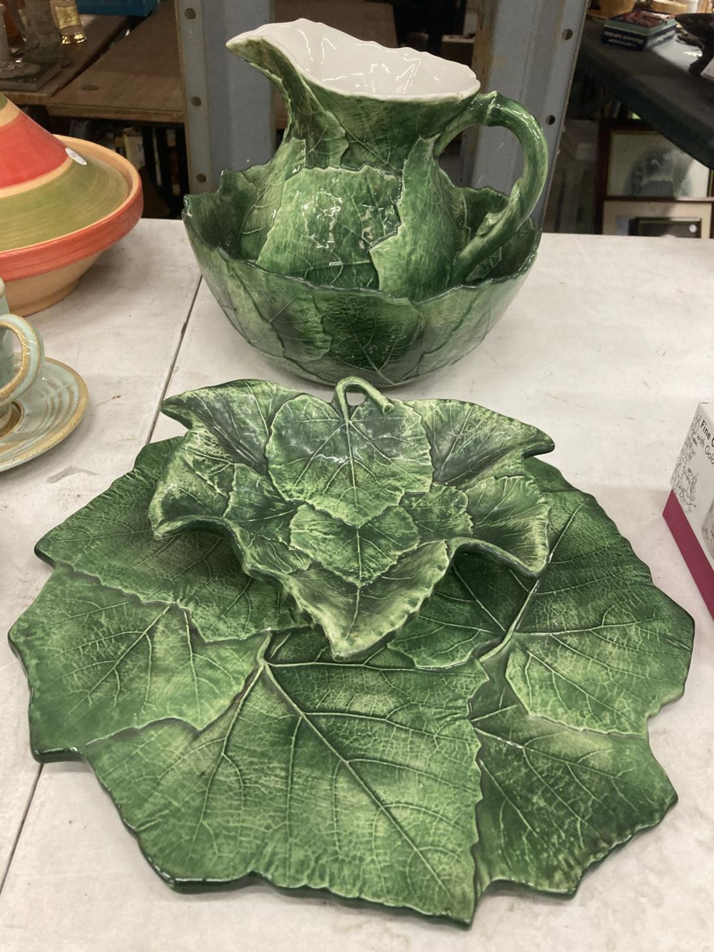 AN ITALIAN CABBAGE LEAF JUG AND BOWL TOGETHER WITH STAND AND DISH