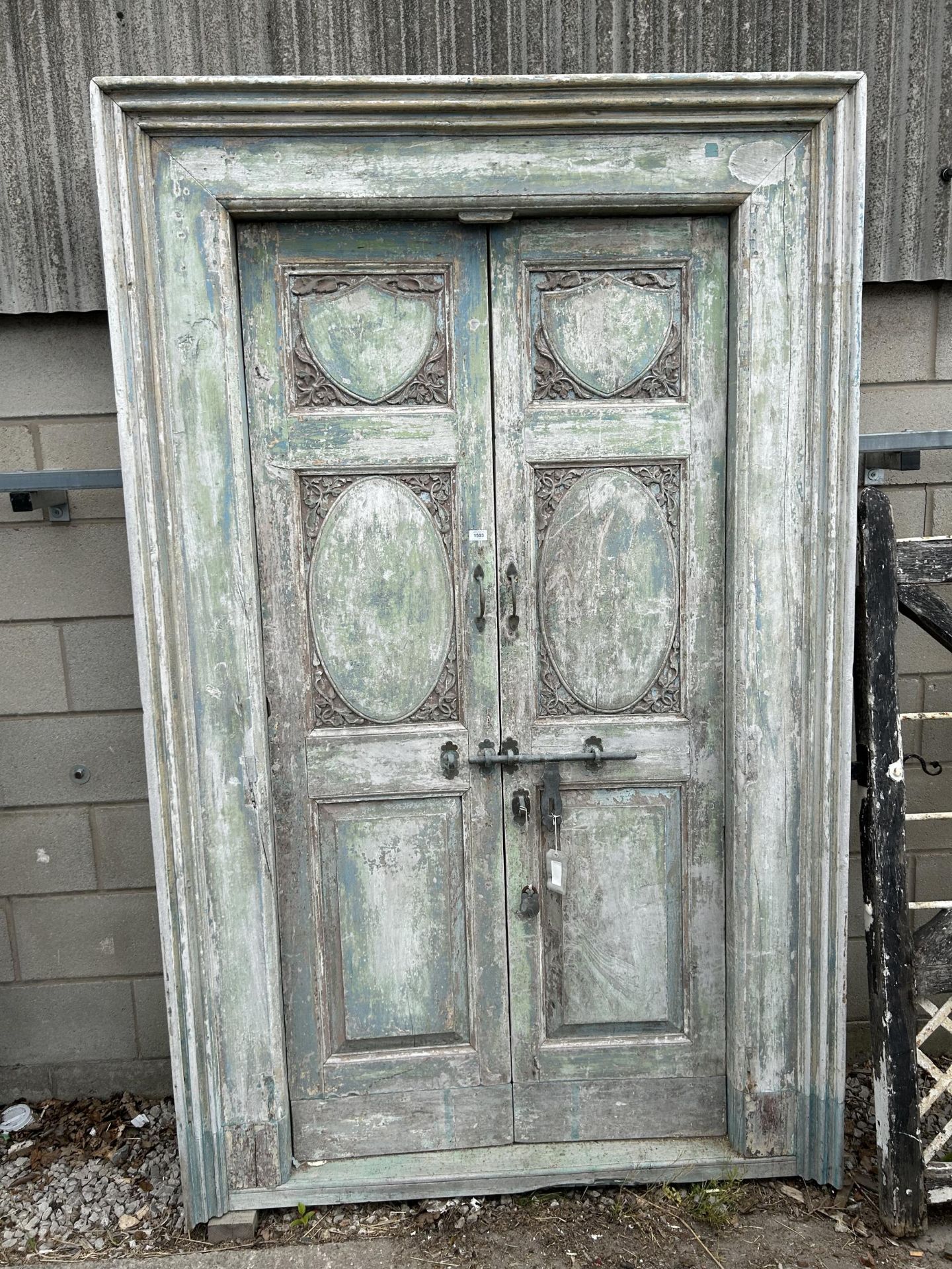 A PAIR OF INDIAN HARDWOOD PANELLED DOORS 89" x 56" TO INCLUDE FRAME WITH BRASS HASP AND HANDLES