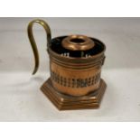 AN ARTS AND CRAFTS COPPER CANDLESTICK WITH BRASS HANDLE WITH TRADE MARK STAMP TO BASE