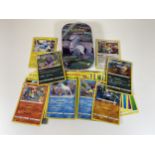 A TIN OF ASSORTED POKEMON CARDS, HOLOS, RARES ETC