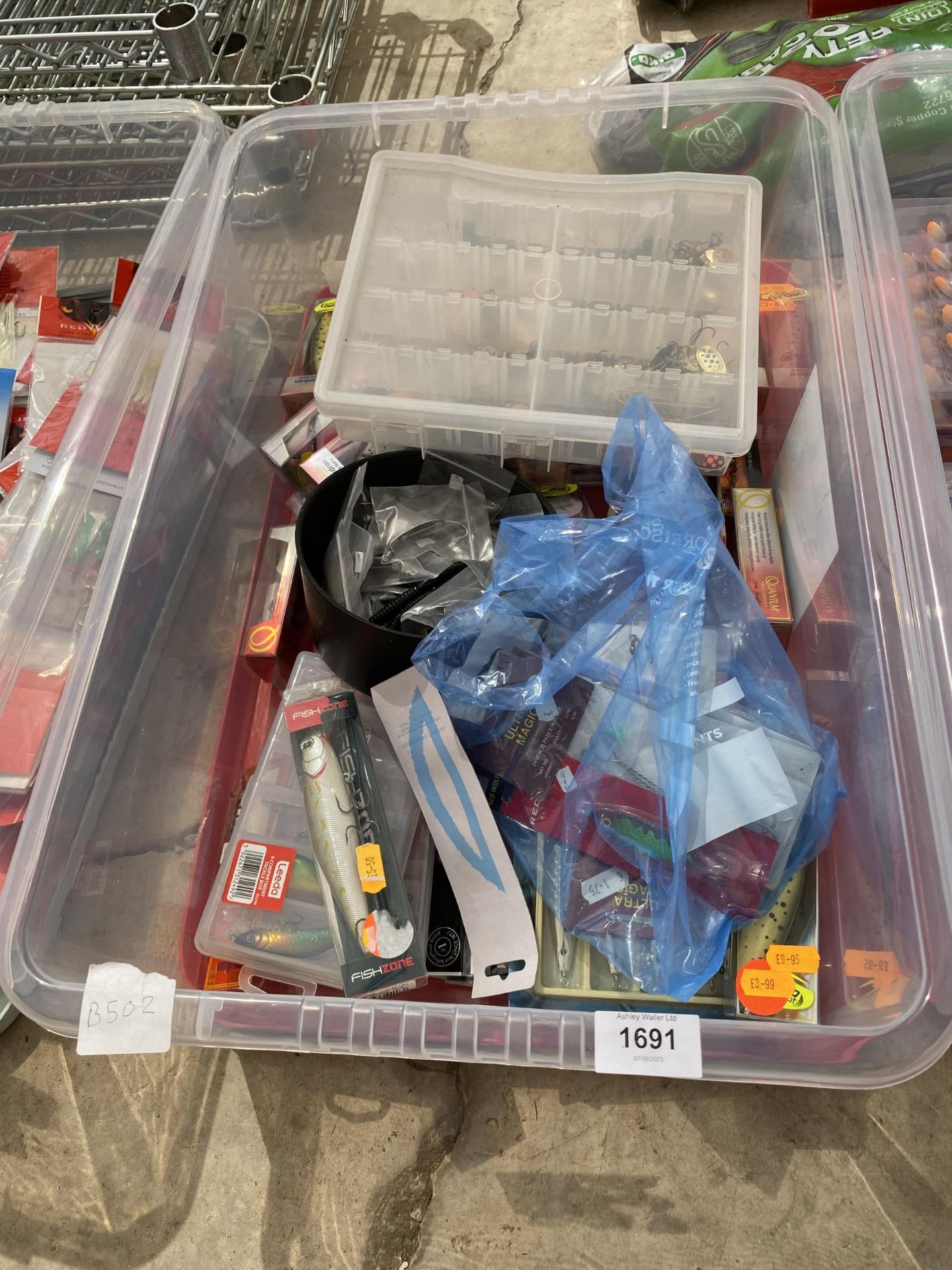 A BOX CONTAINING AN ASSORTMENT OF PLUGS AND SPINNERS (FROM A TACKLE SHOP CLEARANCE)