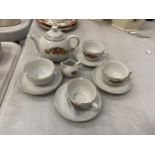 A VINTAGE CHILD'S CERAMIC TEASET TO INCLUDE FOOUR CUPS AND SAUCERS, A TEAPOT AND A CREAM JUG