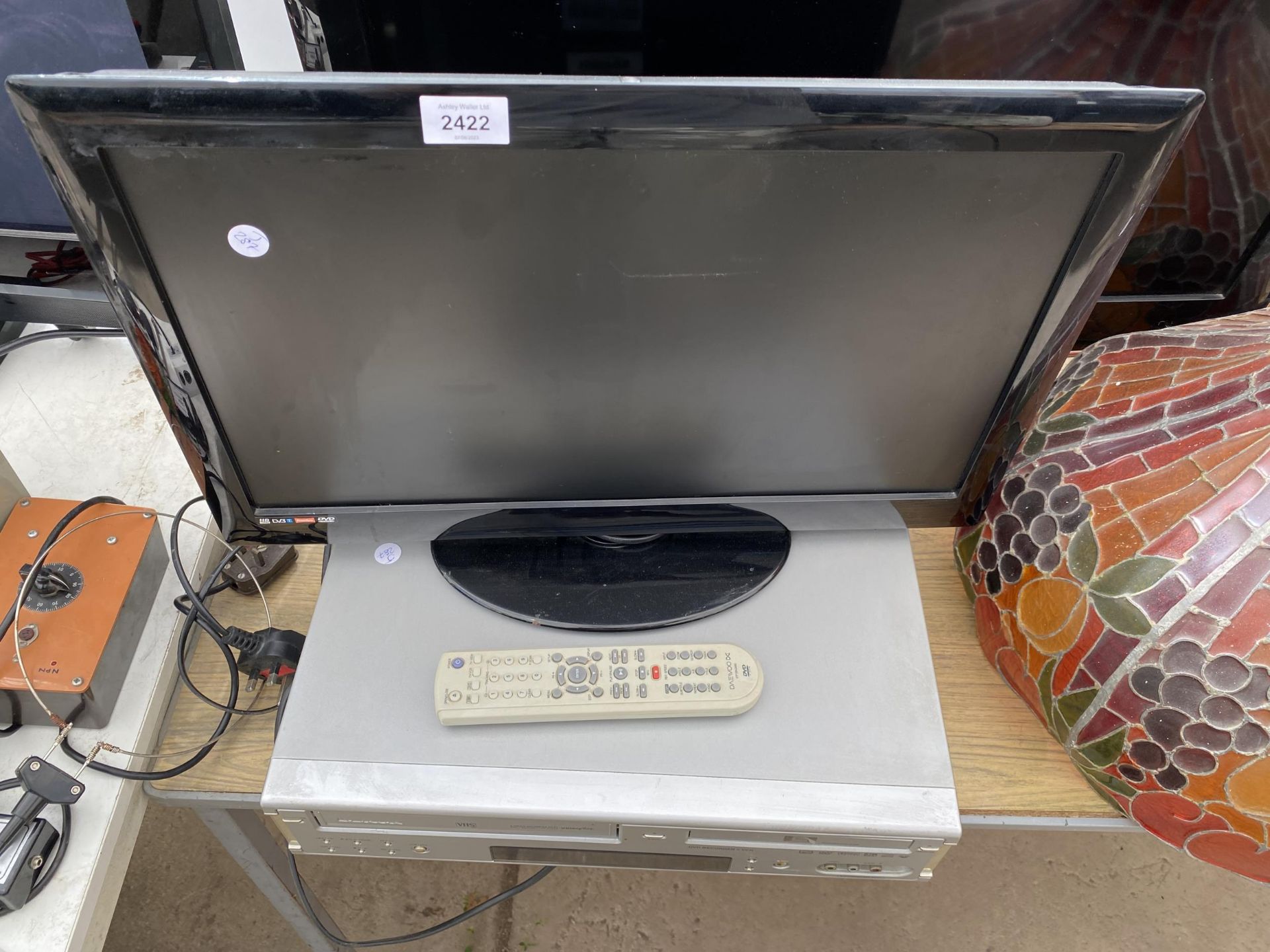A 22" TELEVISION AND A DAEWOO VHS/DVD PLAYER