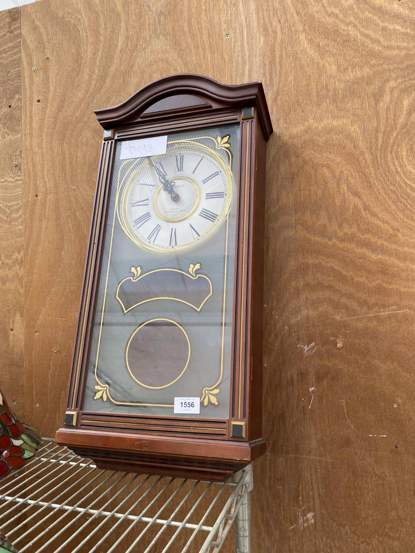 A WOODEN CASED WESTMINISTER CHIME QUARTZ WALL CLOCK