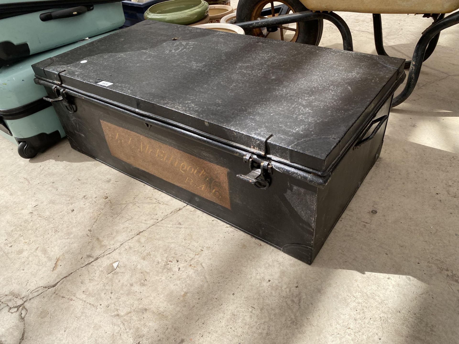 A LARGE METAL TRAVEL TRUNK