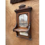 A WOODEN WALL MIRROR WITH LOWER SHELF AND FURTHER LOWER MIRROR