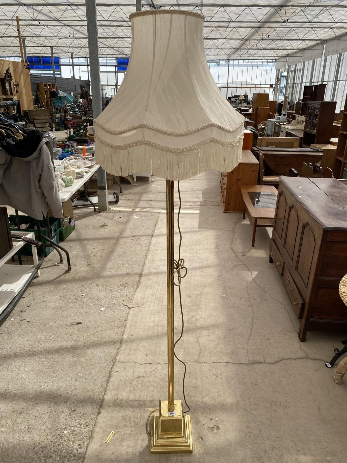 A BRASS STANDARD LAMP ON STEPPED BASE, COMPLETE WITH SHADE