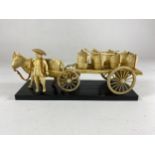 AN ORIENTAL BONE EFFECT MODEL OF A CHINESE MAN WITH HORSE AND CART