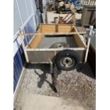 A WOODEN AND METAL CAR TRAILER WITH TWO SPARE TYRES