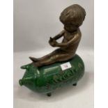 A GREEN VICTORIAN CERAMIC PIG WITH BRONZE MODEL OF A BOY SEATED, HEIGHT 34CM