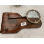 A BRASS MAGNIFYING GLASS IN A LEATHER POUCH