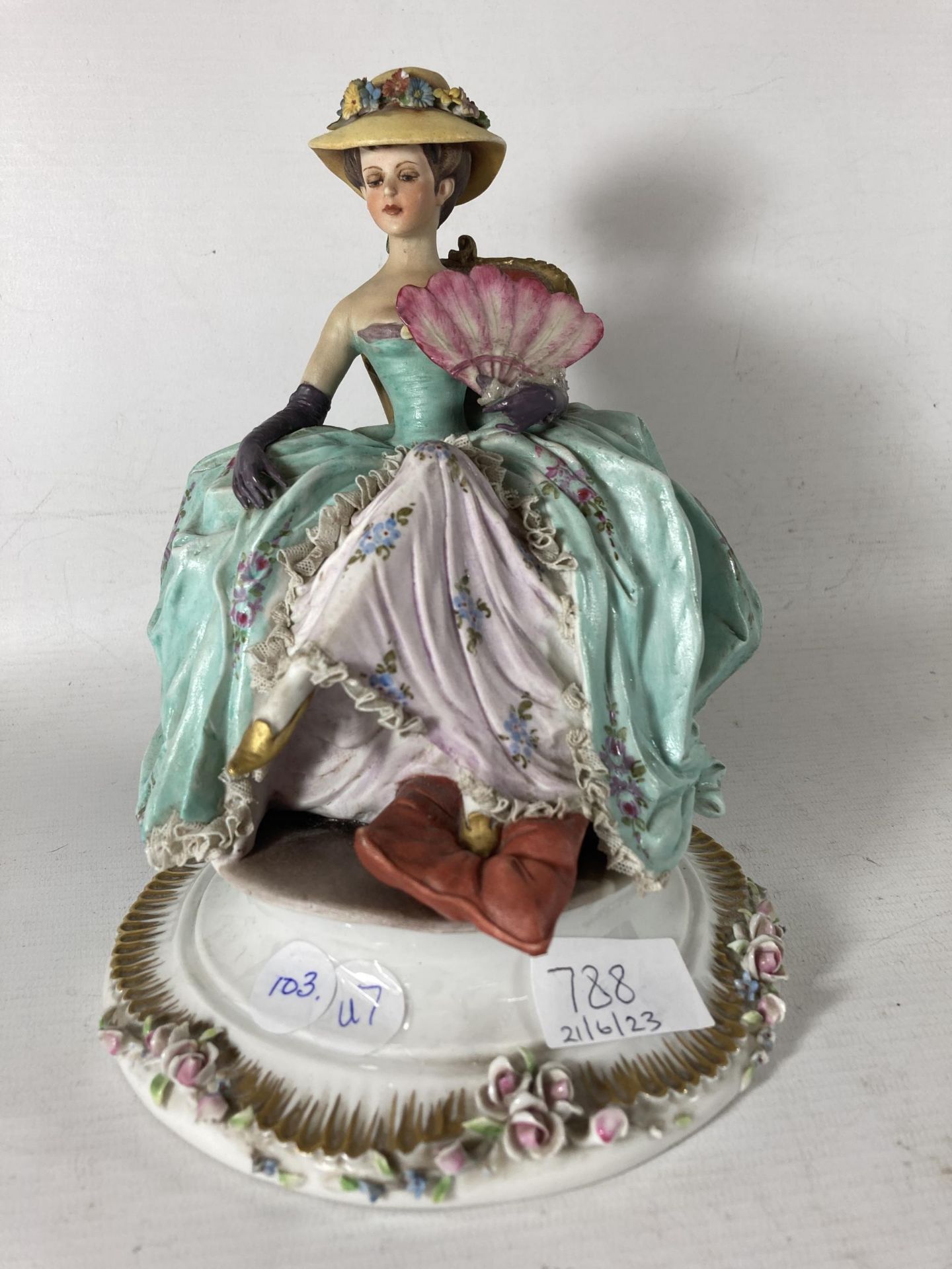 A VINTAGE CAPODIMONTE FIGURE OF A LADY AT REST
