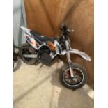 A CHILD'S MINI MOTO MOTORCYCLE WITH KEY