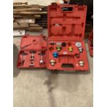 A PART COMPLETE CASED COOLING SYSTEM PRESSURE TESTER AND A CASED SPARK PLUG PULLING KIT