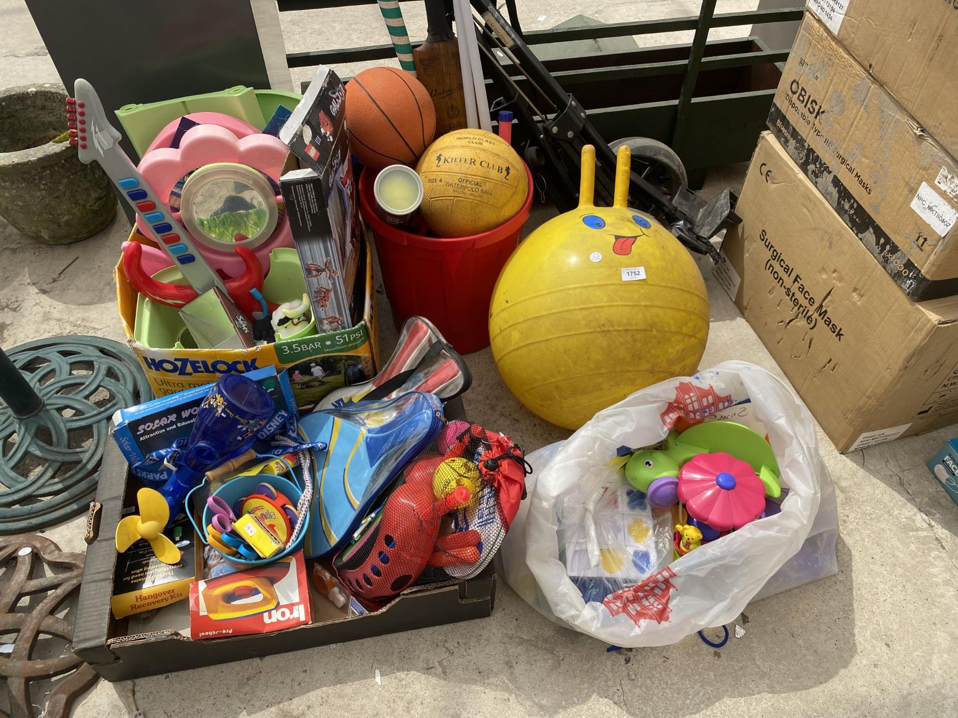 AN ASSORTMENT OF CHILDRENS TOYS AND SPORTS EQUIPMENT