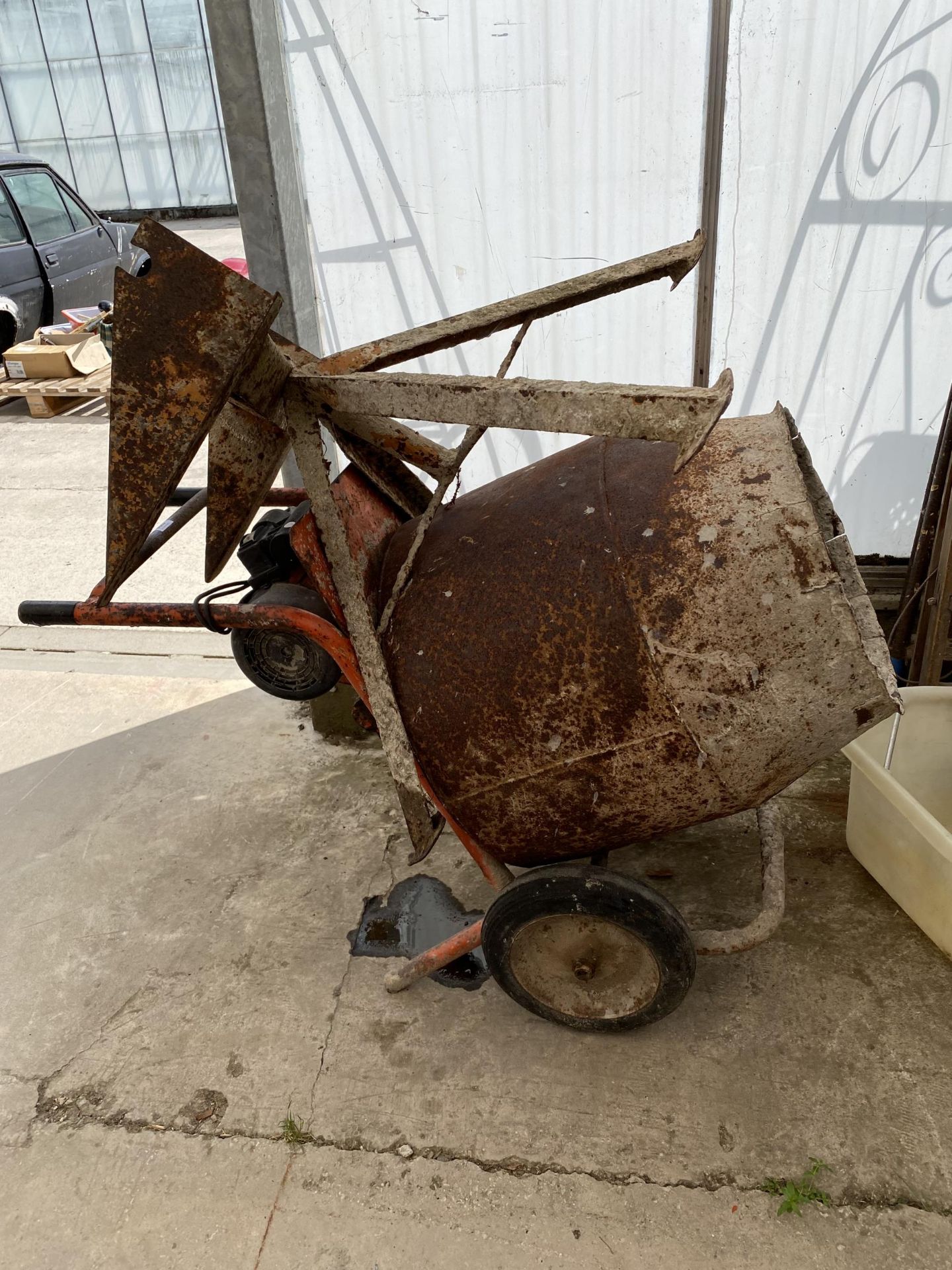 AN ELECTRIC CEMENT MIXER COMPLETE WITH STAND