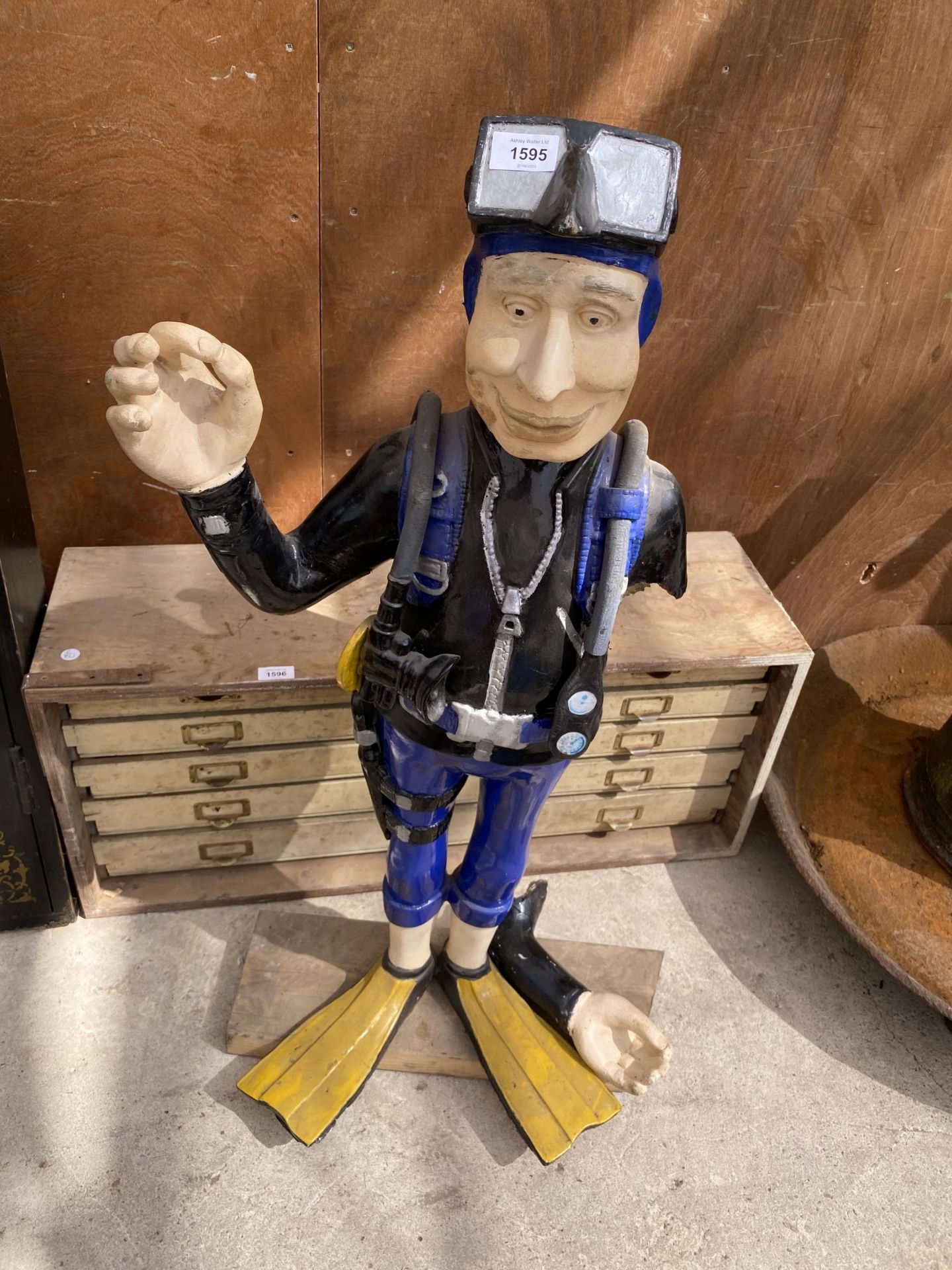 A FIBRE GLASS FIGURE OF A SCUBA DIVER