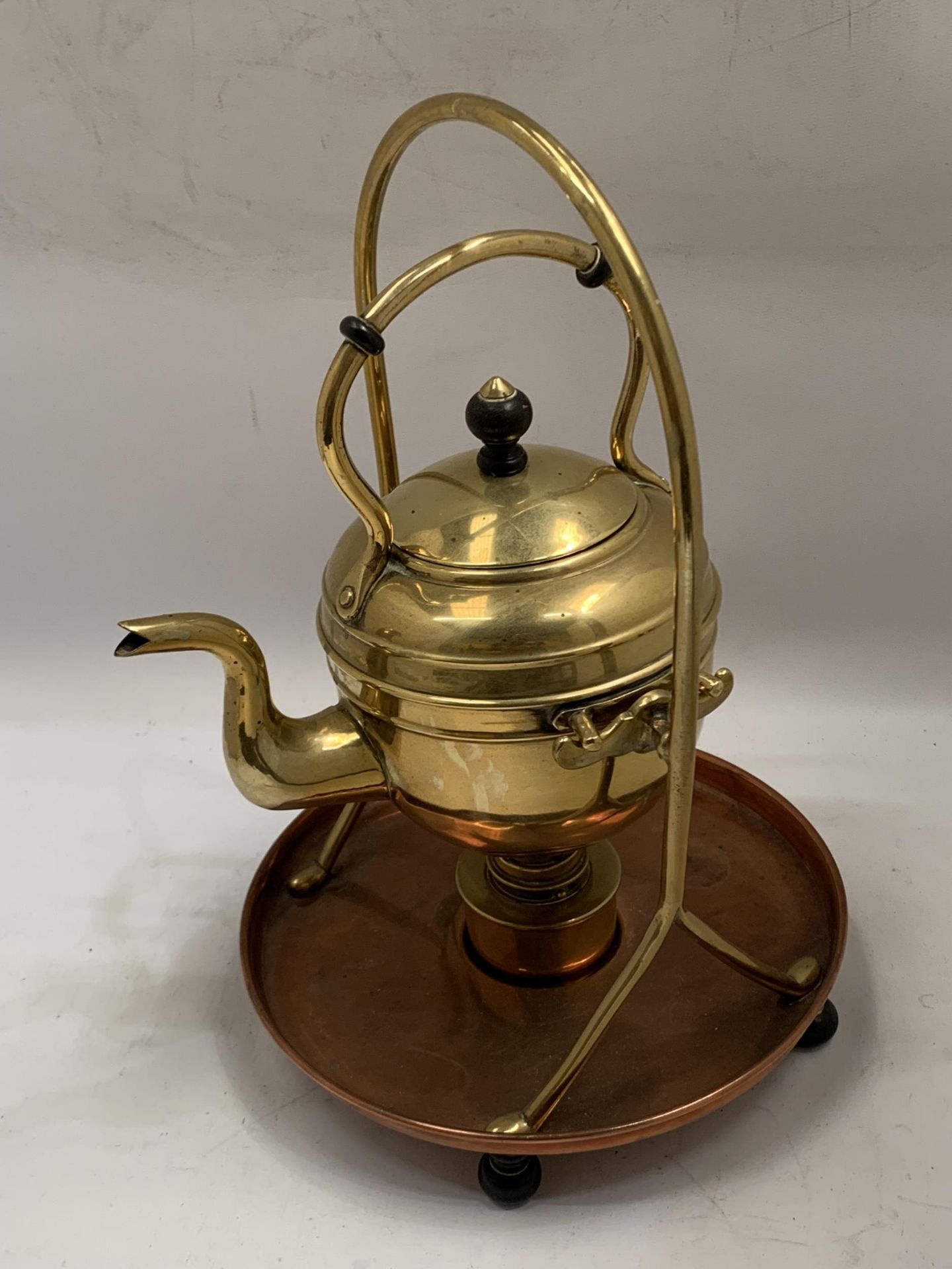 A VINTAGE BRASS AND COPPER SPIRIT KETTLE