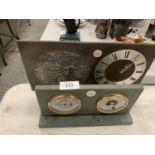 A SLATE MANTLE CLOCK WITH A SHEPHERD AND SHEEPDOG IMAGE AND A SLATE BAROMETER AND HYGROMETER