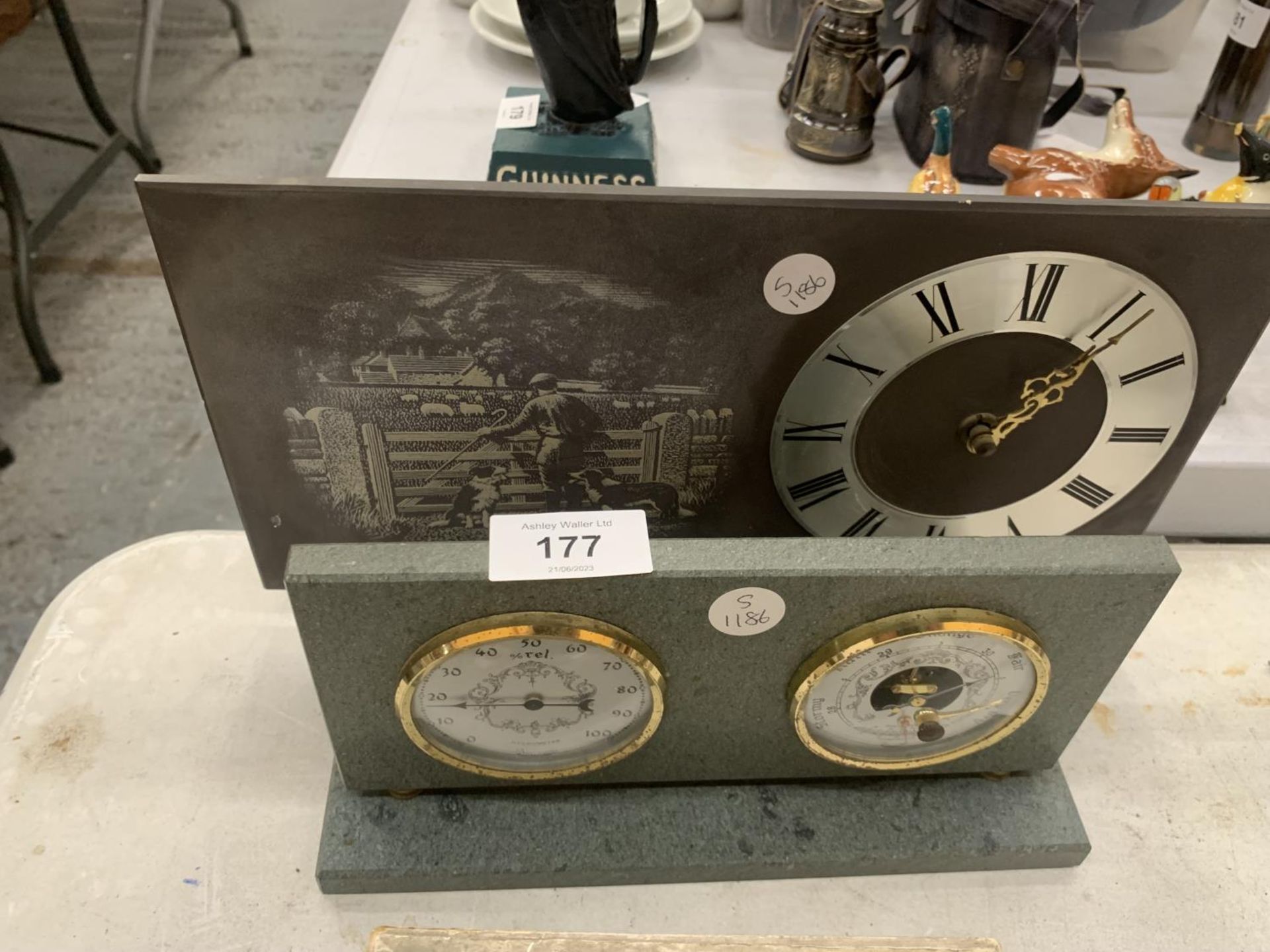 A SLATE MANTLE CLOCK WITH A SHEPHERD AND SHEEPDOG IMAGE AND A SLATE BAROMETER AND HYGROMETER