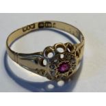 AN 18 CARAT GOLD RING WITH CENTRE RUBY SURROUNDED BY SEVEN DIAMONDS SIZE Q/R GROSS WEIGHT 2.58 GRAMS