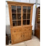 A VICTORIAN PINE TWO DOOR GLAZED CABINET ON BASE ENCLOSING TWO DRAWERS AND TWO CUPBOARDS, 49" WIDE