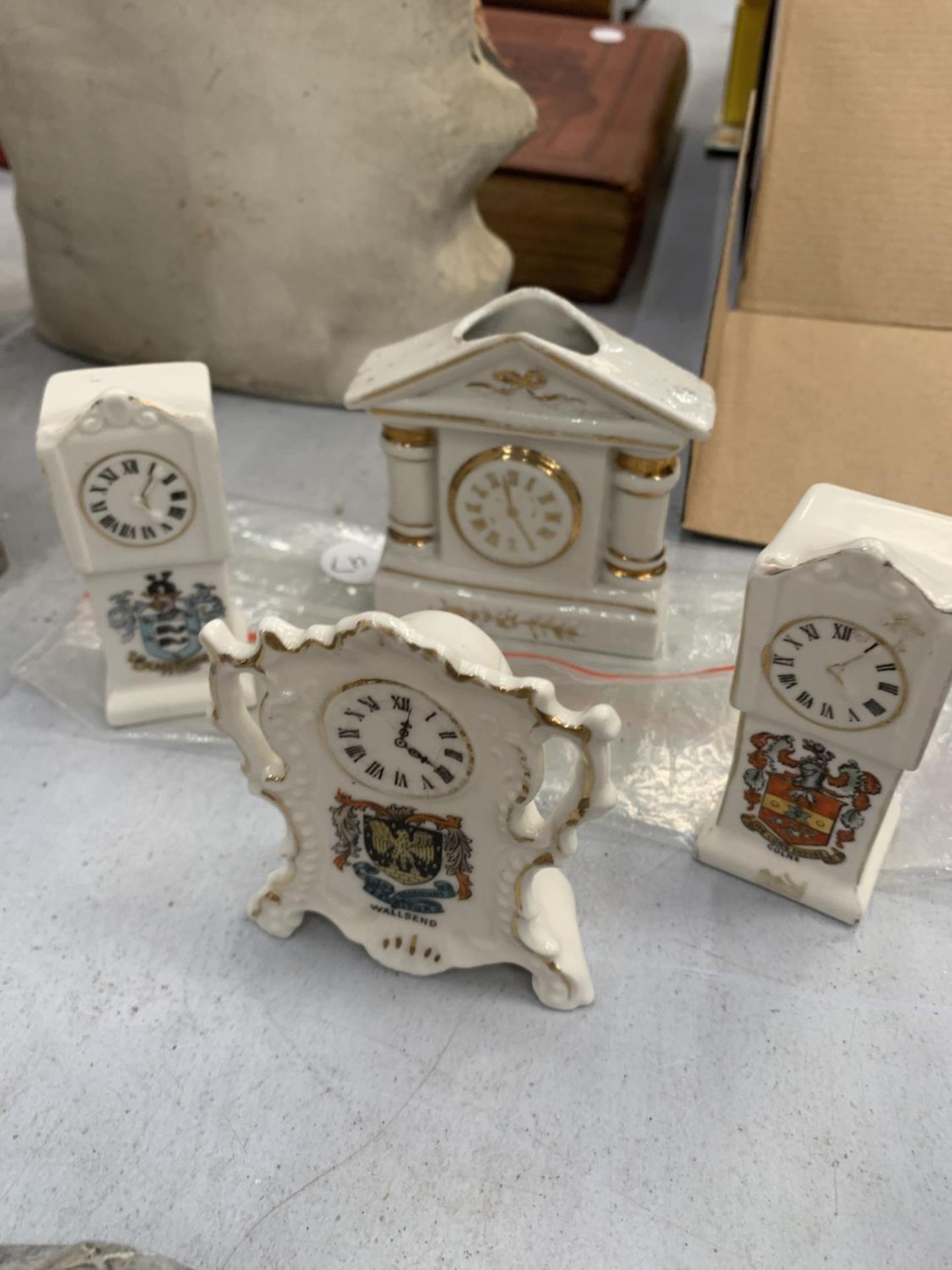 FOUR CRESTED WARE CLOCKS