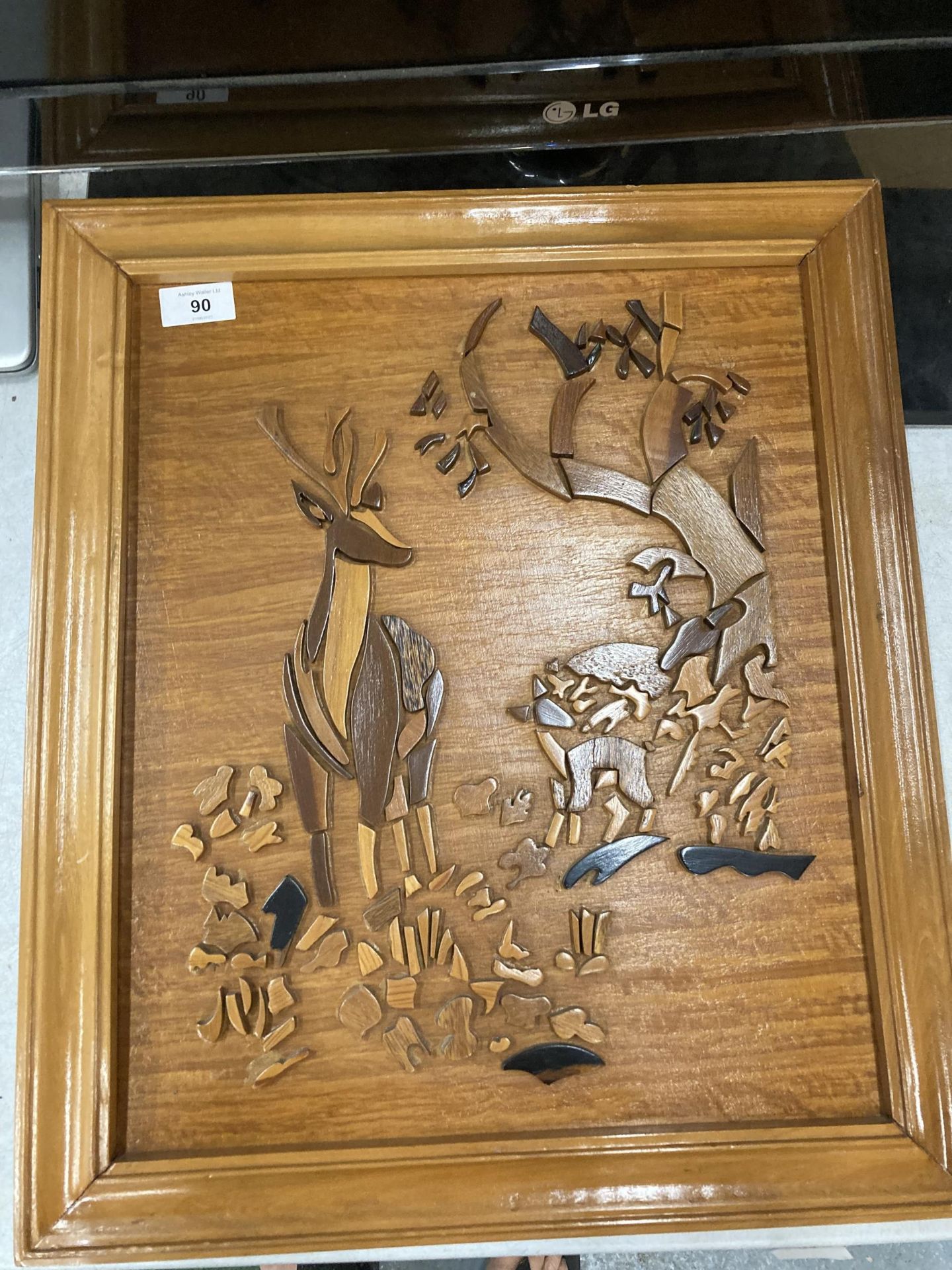 A CARVED WOODEN DEER PICTURE