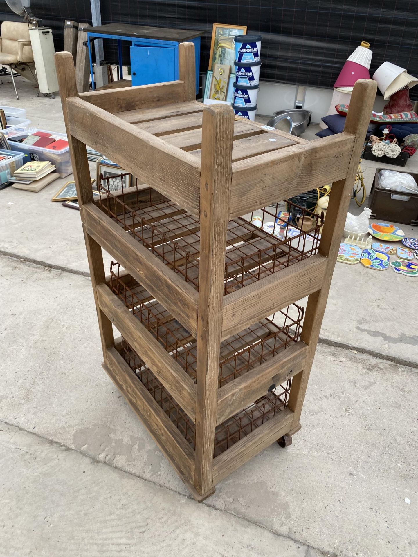 A TALL RUSTIC FOUR TIER WOODEN FOUR WHEELED STAND WITH WIRE BASKET TRAYS - Image 3 of 6