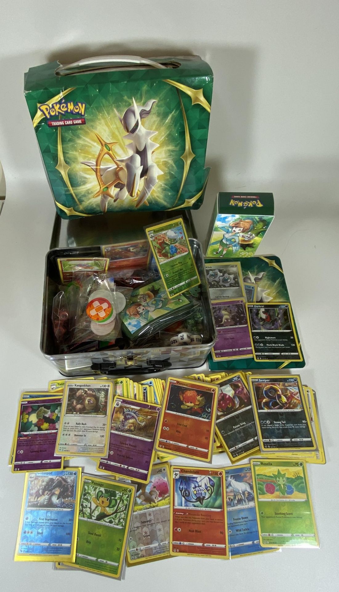 A POKEMON TIN TRAINER BOX FULL OF CARDS, GAME COUNTERS, RARES, HOLOS ETC